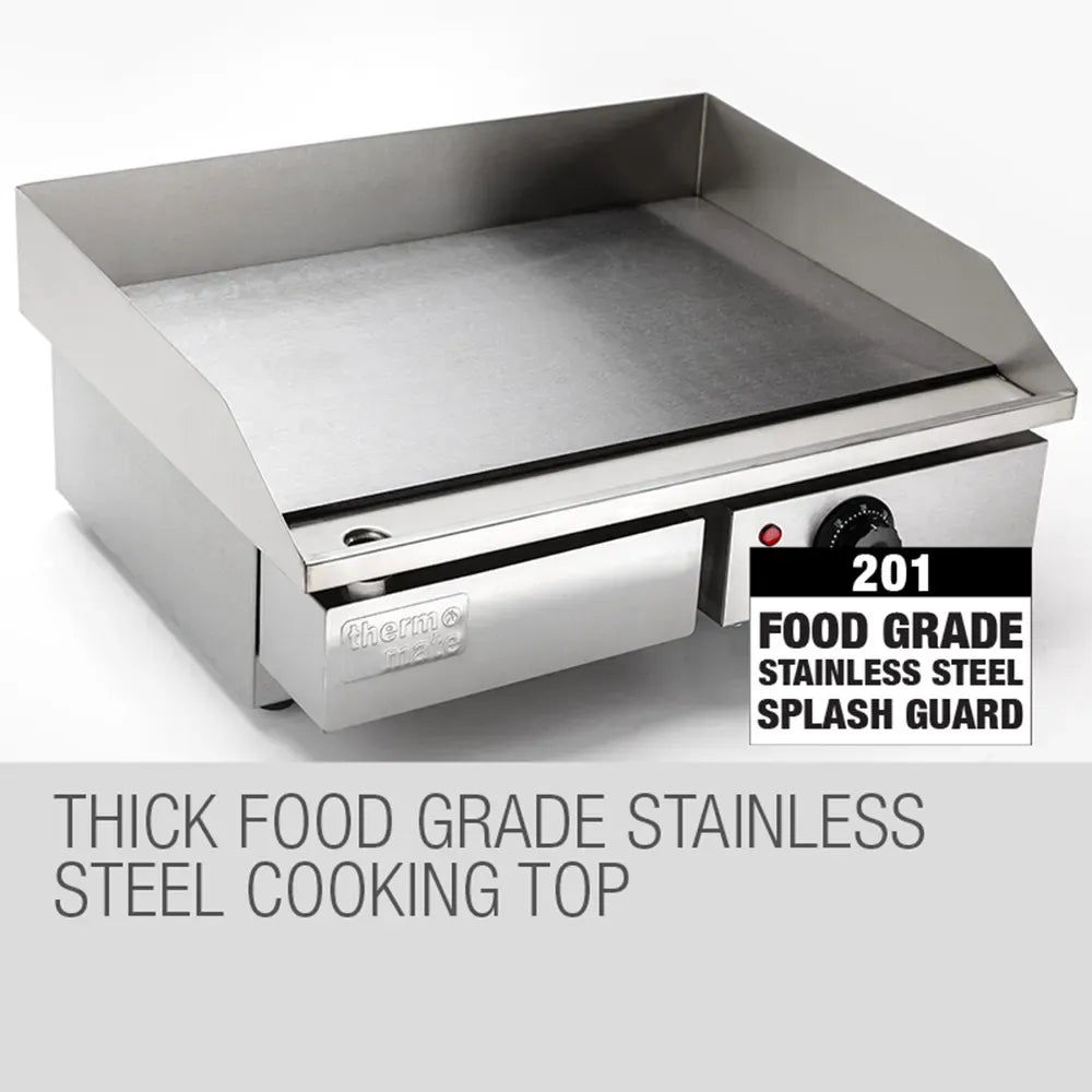 Stainless steel cooking top with splash guard on a white background