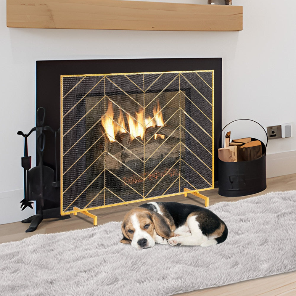 Dog lying on a rug in front of a fireplace with decorative screen