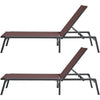 Two brown lounge chairs with black frames on a white background