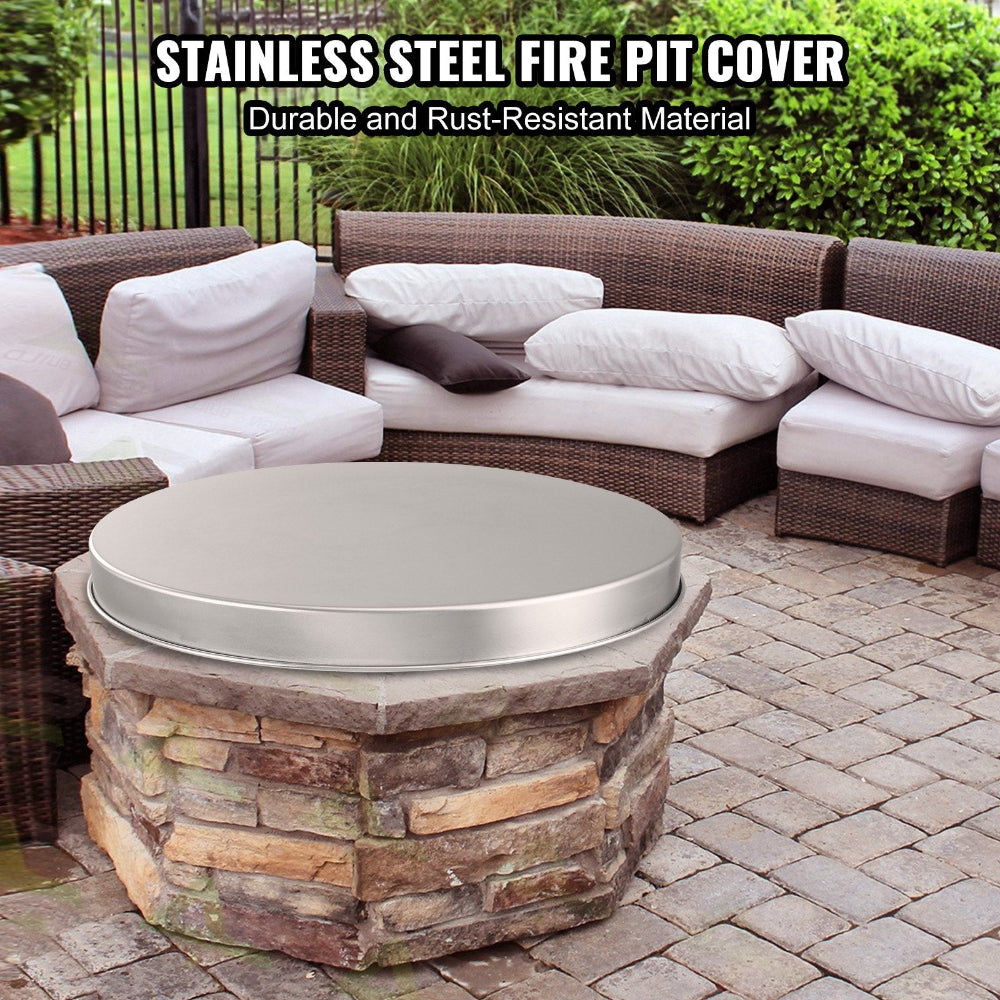 Stainless steel fire pit cover on a stone fire pit with outdoor furniture in the background
