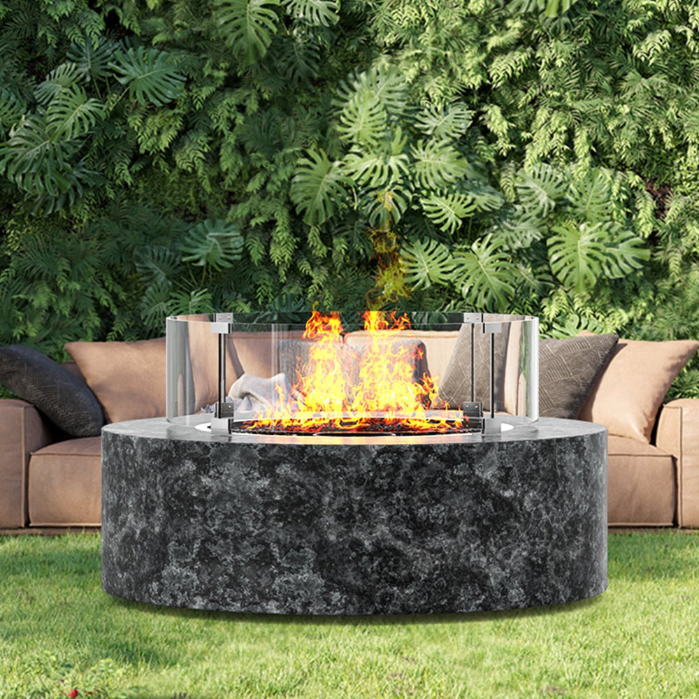 Outdoor fire pit with flames in a garden setting