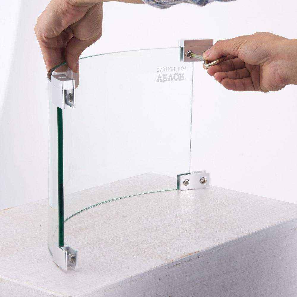 Glass display case with a person using a tool to adjust it on a white surface.