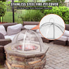 Stainless steel fire pit cover on a stone fire pit with outdoor furniture in the background.