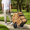 Person pushing a cart full of firewood in a park setting