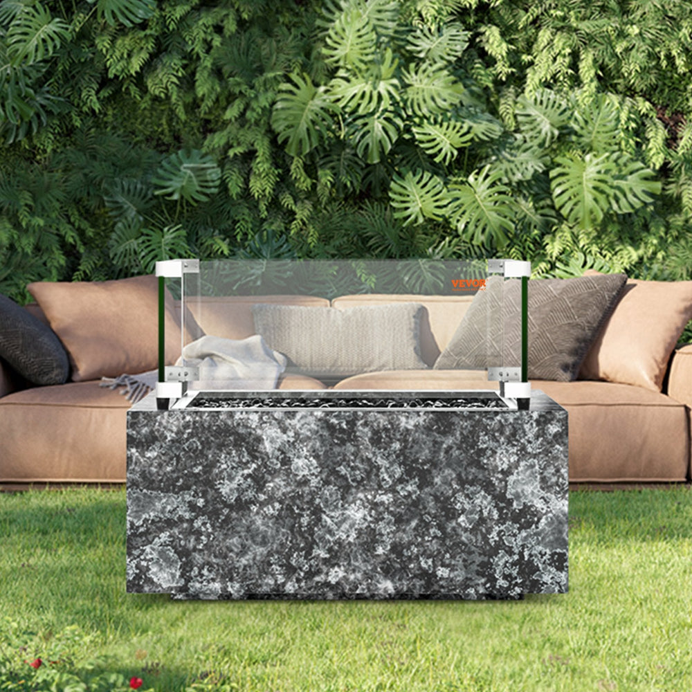 Outdoor fire pit table with marble-like design in a garden setting