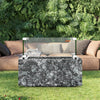 Outdoor fire pit table with marble-like design in a garden setting