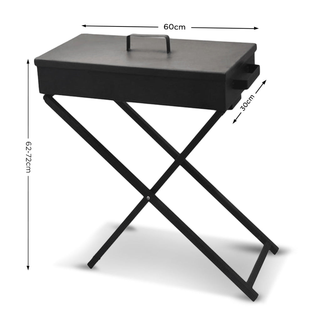 Portable charcoal grill with lid and foldable legs on a stand showing its dimensions and set on a solid white background.