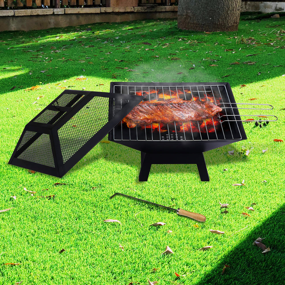 Portable grill with food on a grassy outdoor area