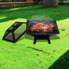 Portable grill with food on a grassy outdoor area