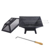 Portable grill with mesh lid and wooden-handled tool on a white background