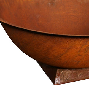Close up view of cast iron fire pit bowl sitting on  trivet base