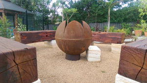 The Lotus Fire Pit in a pretty garden setting