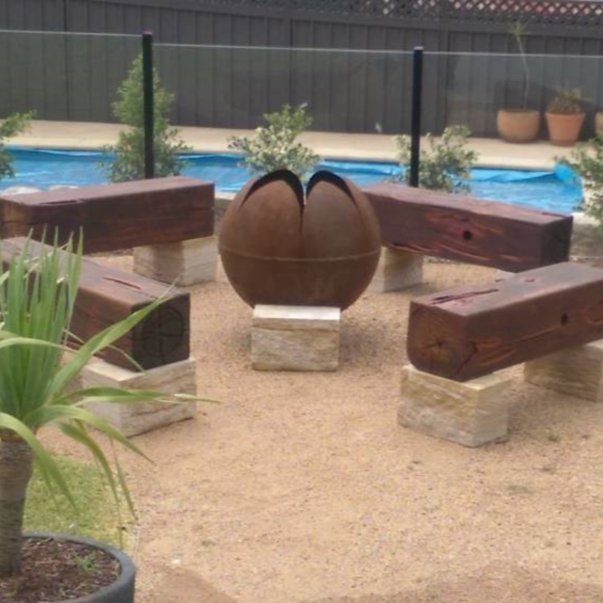 The Lotus Fire Pit in poolside garden setting