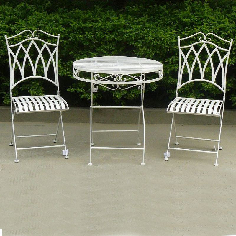 Albany 3 Piece Wrought Iron Setting in white on a cement floor area in front of green hedges.