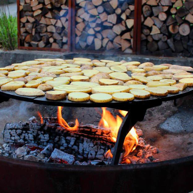 Yagoona Barramundi wood BBQ cooking potatoe slices over wood flame.