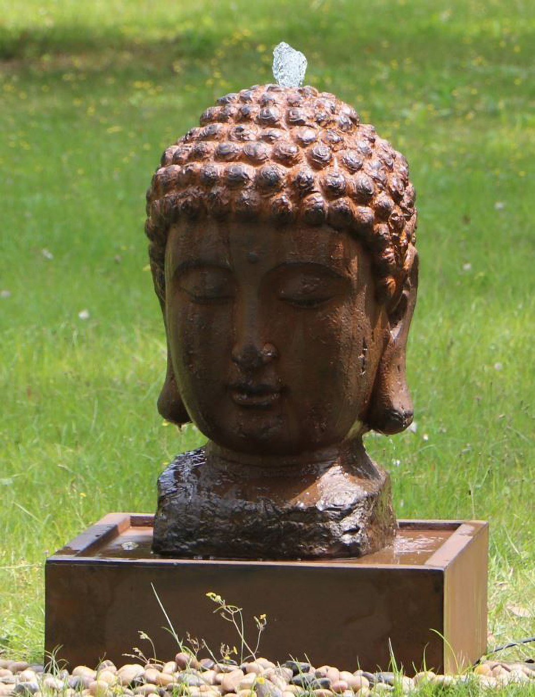 Lucky Buddha Water Fountain with water flowing in garden in the day time