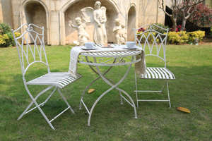White coloured Albany 3 Piece Wrought Iron Setting in a garden setting