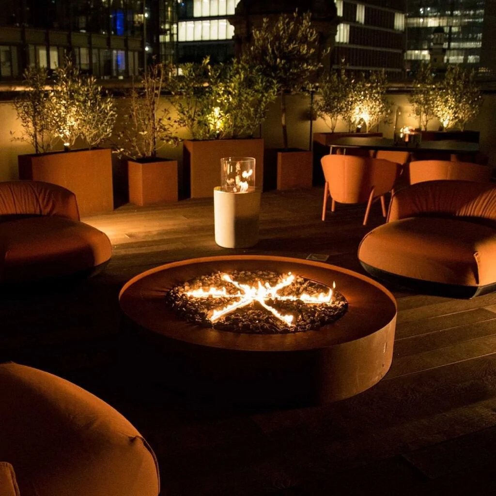 Galio Star Automatic Outdoor Gas Fireplace in corten showing the star flame burning