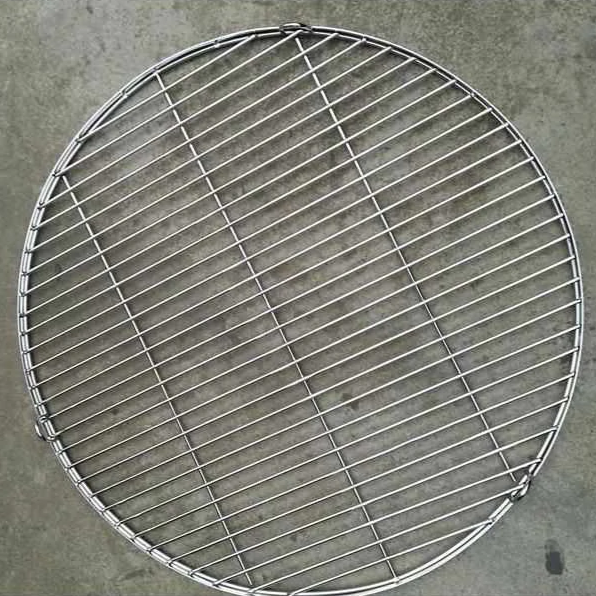 Full round Stainless Steel BBQ fire pit Cooking Grill on a cement floor