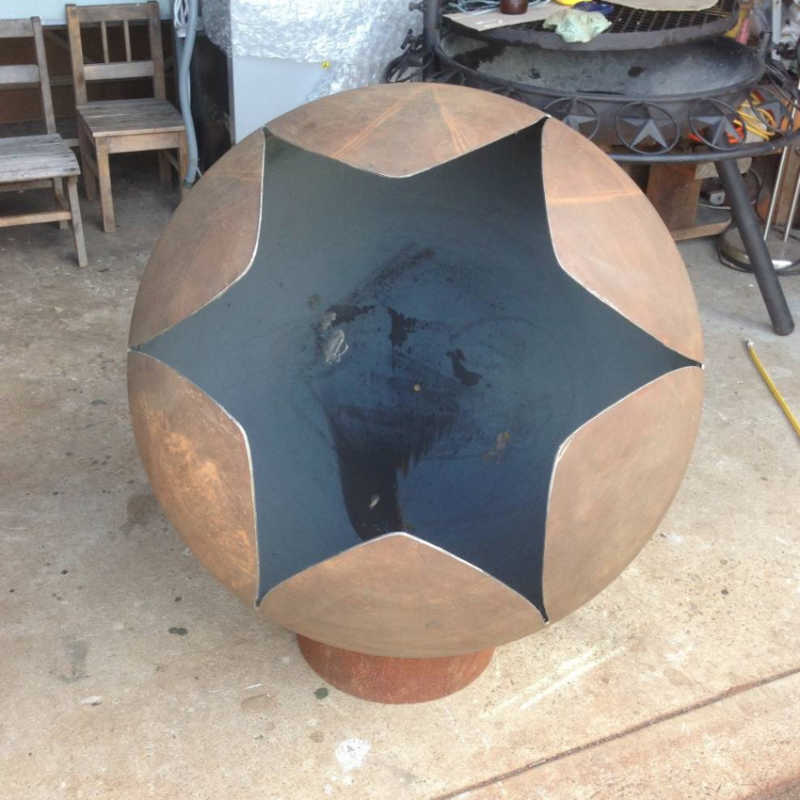 Looking down from above into the rust coloured Lotus Fire Pit showing its stunning star shaped flower design 