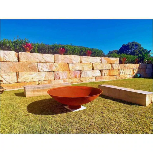  The Cauldron Fire Pit 1500mm in garden setting with large stone bench seats 