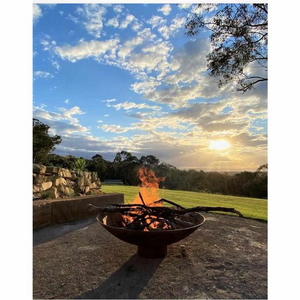 The Cauldron Fire Pit 1500mm burning a fire with sunset in background