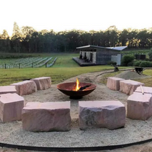 Load image into Gallery viewer, The Cauldron Fire Pit 1500mm in rural setting with large stone seats around it
