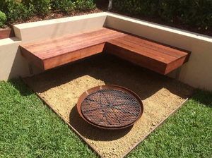Cauldron Cast Iron Fire Pit and metal grill in an outdoor area