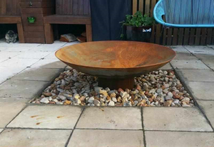 Cauldron 80cm Cast Iron Fire Pit in an outdoor area