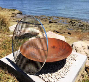 The Cauldron Cast Iron Fire Pit with stainless steel BBQ grill