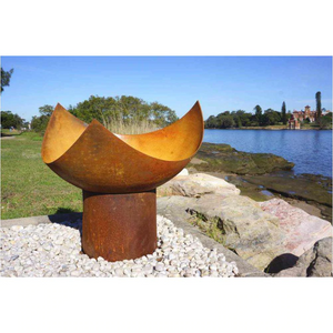 he Chalice Fire Pit in natural rust colour at the seaside 