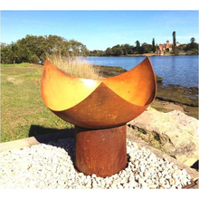 Load image into Gallery viewer, The Chalice Fire Pit beside the sea in natural rust finish