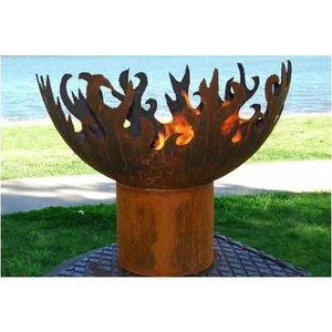 The Flame Dancer Fire Pit near a beach with a fire burning