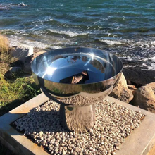 Load image into Gallery viewer, The Goblet Stainless Steel Fire Pit at the seaside on a 30cm high stand