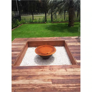 The Teppanyaki Fire Pit in backyard setting with lid on