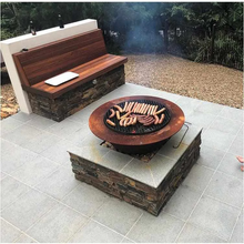Load image into Gallery viewer, The Teppanyaki Cast Iron Fire Pit cooking a sausage sizzle