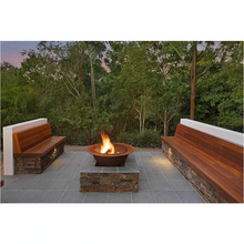 Load image into Gallery viewer, The Teppanyaki Fire Pit burning a fire in a garden setting