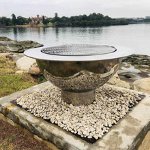 Load image into Gallery viewer, The Teppanyaki Stainless Steel Fire Pit and grill beside a lake