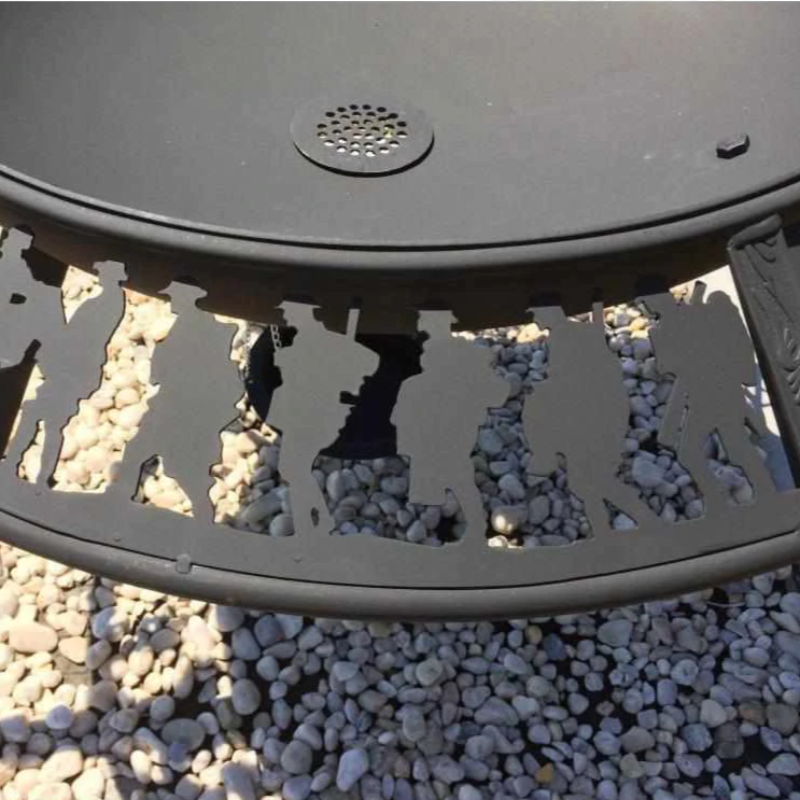Close up of soldiers on the Anzac pattern on the Ultimate BBQ Fire Pit with gravel stones beneath it.