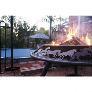 The Ultimate BBQ Fire Pit burning a fire near poolside