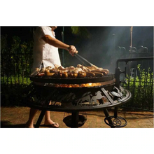 Load image into Gallery viewer, Sausages and wings cooking on the Ultimate BBQ Fire Pit 