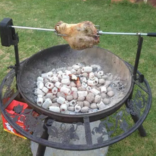 Load image into Gallery viewer, The Ultimate BBQ Fire Pit with a lamb roast cooking on spit